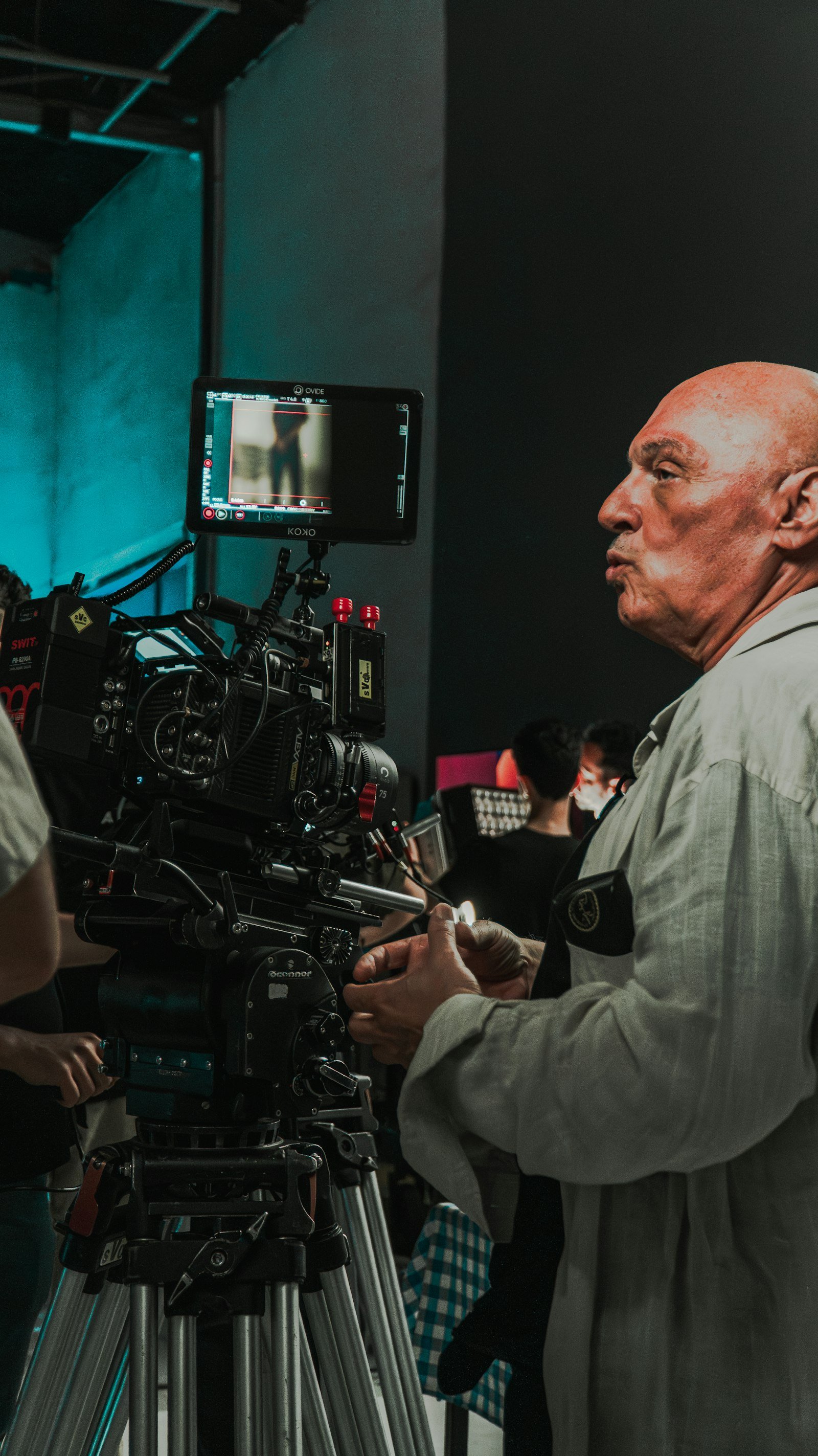 Filmmaker beside a professional cinema camera on set